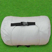 Sleeping Bag Grey with compression sack on green grass