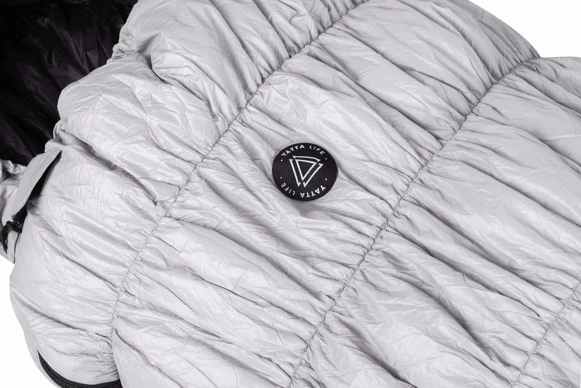 Grey goose down sleeping bag with Yatta Life logo, lightweight and weather-resistant for outdoor adventures.